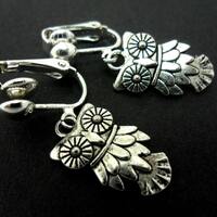 A pair of cute little tibetan silver owl themed  dangly clip on  earrings.
