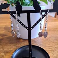 Silver coloured drop earrings featuring owls