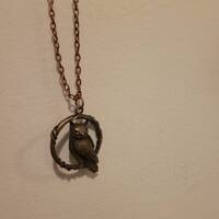 Owl perched in wreath pendanf