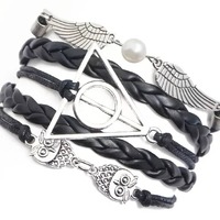 Leather bracelet with wings, owls, and triangular charm