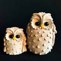 Two ceramic owl figures for a gift, ornamented sculpture of owls made of natural clay for home decor