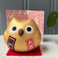 Japanese Maneki Neko, gold lucky owl for good Fortune with Money Feng Shui.