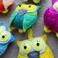 Wonderful felt owl keyrings with lovely embroidery and applique decoration and tiny buttons .
