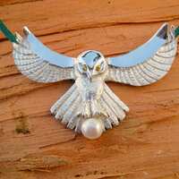 A "Fly me to the moon..." Owl pendant featuring gem eyes and pearl "catch" in th