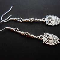 A pair of tibetan silver  owl themed dangly earrings. New.