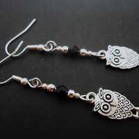 A pair of tibetan silver and black bead owl themed dangly earrings. New.