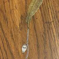 Bronze feather bookmark with owl charm and yellow dried flower ball