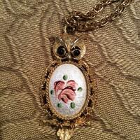 Vintage owl necklace goldtone with enameled centerpiece of pink flowers and green leaves on a white