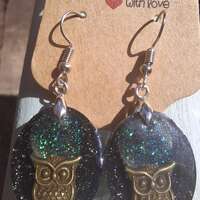 Handmade resin earrings with owl charm and sparkly moonlit sky.