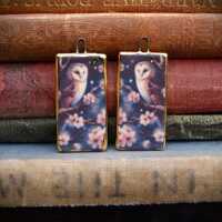 Handmade ceramic charms: illustration of an owl sat on a branch surrounded by blossom with a 24kt go
