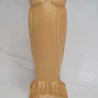 Carved wooden owl with orange eyes