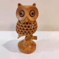 An owl on tree, one piece , five inche with a child in the net ( Stomach). Very traditional for gift