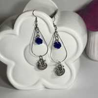 Owl charm hoop earrings featuring a blue rose bead.
