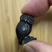 A tiny vintage miniature 'Owl of Minerva' of cast white metal with bronze finish