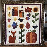 Autumn sampler quilt, fall leaves, sunflowers, blackbirds, owls, pumpkin, acorns and a fox, fall col