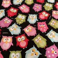 Owl Fabric . Pink,neon green,blue,hot pink, and red owls on a black background