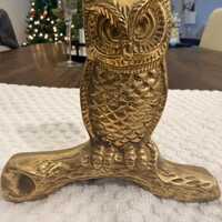 Vintage brass owl resting on a branch