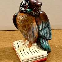 Vintage hand-painted ceramic or chalkware owl figurine perched on a book
