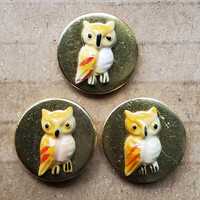 Set of three small unusual brass owl buttons.