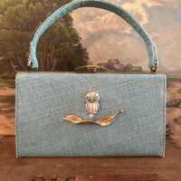 Vintage 1950s Tiffany-blue purse adorned with vintage Trifari feather brooch and white owl with cost
