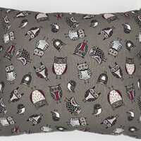 Square pillow with multi colored adorable owls set on a light grey background