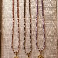 Greek Athena owl pendant on Ethiopian opal and various gemstone bead necklaces