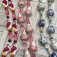Blue and white ceramic owl, pink flamingos, pink rabbit bead strands
